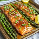 - 4 salmon fillets (about 6 oz each) - 1 bunch of asparagus, ends trimmed - 1/4 cup pure honey - 3 tablespoons soy sauce - 3 cloves garlic, minced - 1 tablespoon fresh ginger, finely grated - 2 tablespoons extra virgin olive oil - Salt and freshly cracked pepper to taste - 1 tablespoon sesame seeds (for garnish) - 2 green onions, thinly sliced (for garnish) - Lemon wedges (for serving) The main ingredients bring together rich flavors. Salmon offers healthy fats and protein. Asparagus adds a fresh crunch. Honey gives a sweet touch, while soy sauce adds depth. Garlic and ginger boost the taste with their warmth. For seasonings, use olive oil to enhance the veggies. Salt and pepper elevate the dish. Sesame seeds and green onions add a lovely finish. Lemon wedges provide a bright zing when served. This mix of ingredients makes a fantastic meal. You get balance from protein and veggies. Plus, the sweet and savory combo makes it a crowd-pleaser. Remember, using fresh ingredients enhances the flavor. - Preheat the oven to 400°F (200°C). - Line a baking sheet with parchment paper. - Whisk together honey, soy sauce, garlic, and ginger. - Place salmon fillets and asparagus on the baking sheet. - Season and coat with marinade. - Bake the salmon and asparagus for 12-15 minutes. - Drizzle remaining sauce and return to oven for finishing. - Rest the dish, garnish, and serve with lemon wedges. Follow these steps to create a bright and tasty meal. This honey garlic salmon and asparagus dish cooks quickly, and the flavors blend perfectly. Enjoy every bite! How to ensure the salmon is perfectly cooked: To cook salmon just right, watch the time closely. Bake it for 12-15 minutes. The fish is ready when it flakes easily with a fork. If you have a meat thermometer, aim for an internal temperature of 145°F (63°C). Avoid overcooking, as it can dry out the fish. Tips for crispy asparagus: For crispy asparagus, make sure to trim the ends for even cooking. Toss it with olive oil, salt, and pepper before baking. Spread the asparagus in a single layer on the baking sheet. Crowding can lead to steaming instead of roasting, which makes it less crispy. Presentation ideas for serving: For a rustic look, serve the salmon and asparagus directly on the sheet pan. If you want a fancier touch, plate each component separately. Garnish with lemon wedges and a sprinkle of sesame seeds for color and flair. Pairing options with side dishes: This dish pairs well with rice or quinoa for a hearty meal. You can also serve it with a light salad to balance the flavors. Roasted potatoes or garlic bread would complement the dish nicely. Alternatives for honey and soy sauce: If you need a substitute for honey, try maple syrup or agave nectar. For soy sauce, you can use tamari for a gluten-free option. Coconut aminos can also work as a milder alternative. Variations for dietary restrictions: For a low-sugar version, use a sugar-free honey substitute. If you are vegan, replace the salmon with tofu or tempeh. You can marinate these just like the fish for great flavor. Adjust the soy sauce to fit your dietary needs, like using low-sodium or gluten-free options. {{image_4}} You can change the honey garlic marinade easily. If you want a different flavor, try using maple syrup instead of honey. This swap adds a nice, rich taste. You can also add spices or herbs. A pinch of chili flakes gives it heat. Fresh thyme adds a lovely aroma. Experiment with what you like best! While asparagus is a star, you can use other veggies too. Broccoli works well and adds crunch. Bell peppers bring color and sweetness. You can mix and match to find your favorite combo. For a complete meal, add more vegetables. Carrots, zucchini, or snap peas can all fit in. They cook well and make your dish more colorful. You can cook this dish in different ways. Grilling adds a nice smoky flavor. It’s perfect for summer cookouts. Just make sure to keep an eye on the salmon. Baking is simple and easy. It keeps the salmon moist and tender. Follow the recipe for perfect results every time. You can also try making it on a stovetop. Just use a skillet. Cook the salmon skin-side down first. Then, add the asparagus and sauce. This method gives you a nice sear. Enjoy the same great flavor in a new way! To store cooked salmon and asparagus, let them cool first. Place them in a container. Use an airtight container to keep them fresh longer. You can also use a glass dish with a lid. This helps keep the flavors locked in. When you reheat salmon, avoid using high heat. Use a microwave at a low setting. You can also reheat in the oven at 300°F (150°C) for about 10 minutes. Cover the salmon with foil to keep it moist. For asparagus, you can steam it lightly. This keeps it crisp. Yes, you can freeze leftovers. First, wrap the salmon and asparagus tightly in plastic wrap. Then, place them in a freezer bag. Remove as much air as you can. To thaw, place them in the fridge overnight. You can also use the microwave's defrost setting. This method helps maintain the taste and texture. The best temperature to cook salmon is 145°F (63°C). At this temperature, the fish is fully cooked and safe to eat. You can check this by using a food thermometer. Insert the thermometer into the thickest part of the salmon. If it reads 145°F, it’s ready to serve! Cooking asparagus takes about 12 to 15 minutes at 400°F (200°C). Thinner stalks may cook faster, while thicker ones may need a bit more time. Look for bright green color and a tender feel to know they are done. If they are too tough, give them a few extra minutes. Yes! You can use other types of fish like trout, cod, or halibut. Each type has a different cooking time. For thicker fish, increase the cooking time by a few minutes. Always check for doneness with a fork; it should flake easily. You can serve honey garlic salmon with rice or quinoa for a complete meal. A fresh salad or roasted potatoes also pairs well. For a veggie side, try steamed broccoli or a simple green salad to balance the meal. This blog post covered a delicious honey garlic salmon recipe. You learned about easy ingredients, baking steps, and tasty tips. You can create variations, substitute ingredients, and even choose different vegetables. Store leftovers properly for the best taste. Remember to try grilling for a unique flavor. This dish is quick and healthy, perfect for busy days. With practice, you’ll master it and impress everyone at your table. Cooking is all about fun, so enjoy every moment.
