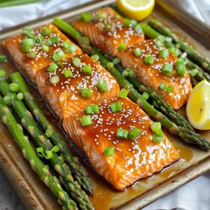 - 4 salmon fillets (about 6 oz each) - 1 bunch of asparagus, ends trimmed - 1/4 cup pure honey - 3 tablespoons soy sauce - 3 cloves garlic, minced - 1 tablespoon fresh ginger, finely grated - 2 tablespoons extra virgin olive oil - Salt and freshly cracked pepper to taste - 1 tablespoon sesame seeds (for garnish) - 2 green onions, thinly sliced (for garnish) - Lemon wedges (for serving) The main ingredients bring together rich flavors. Salmon offers healthy fats and protein. Asparagus adds a fresh crunch. Honey gives a sweet touch, while soy sauce adds depth. Garlic and ginger boost the taste with their warmth. For seasonings, use olive oil to enhance the veggies. Salt and pepper elevate the dish. Sesame seeds and green onions add a lovely finish. Lemon wedges provide a bright zing when served. This mix of ingredients makes a fantastic meal. You get balance from protein and veggies. Plus, the sweet and savory combo makes it a crowd-pleaser. Remember, using fresh ingredients enhances the flavor. - Preheat the oven to 400°F (200°C). - Line a baking sheet with parchment paper. - Whisk together honey, soy sauce, garlic, and ginger. - Place salmon fillets and asparagus on the baking sheet. - Season and coat with marinade. - Bake the salmon and asparagus for 12-15 minutes. - Drizzle remaining sauce and return to oven for finishing. - Rest the dish, garnish, and serve with lemon wedges. Follow these steps to create a bright and tasty meal. This honey garlic salmon and asparagus dish cooks quickly, and the flavors blend perfectly. Enjoy every bite! How to ensure the salmon is perfectly cooked: To cook salmon just right, watch the time closely. Bake it for 12-15 minutes. The fish is ready when it flakes easily with a fork. If you have a meat thermometer, aim for an internal temperature of 145°F (63°C). Avoid overcooking, as it can dry out the fish. Tips for crispy asparagus: For crispy asparagus, make sure to trim the ends for even cooking. Toss it with olive oil, salt, and pepper before baking. Spread the asparagus in a single layer on the baking sheet. Crowding can lead to steaming instead of roasting, which makes it less crispy. Presentation ideas for serving: For a rustic look, serve the salmon and asparagus directly on the sheet pan. If you want a fancier touch, plate each component separately. Garnish with lemon wedges and a sprinkle of sesame seeds for color and flair. Pairing options with side dishes: This dish pairs well with rice or quinoa for a hearty meal. You can also serve it with a light salad to balance the flavors. Roasted potatoes or garlic bread would complement the dish nicely. Alternatives for honey and soy sauce: If you need a substitute for honey, try maple syrup or agave nectar. For soy sauce, you can use tamari for a gluten-free option. Coconut aminos can also work as a milder alternative. Variations for dietary restrictions: For a low-sugar version, use a sugar-free honey substitute. If you are vegan, replace the salmon with tofu or tempeh. You can marinate these just like the fish for great flavor. Adjust the soy sauce to fit your dietary needs, like using low-sodium or gluten-free options. {{image_4}} You can change the honey garlic marinade easily. If you want a different flavor, try using maple syrup instead of honey. This swap adds a nice, rich taste. You can also add spices or herbs. A pinch of chili flakes gives it heat. Fresh thyme adds a lovely aroma. Experiment with what you like best! While asparagus is a star, you can use other veggies too. Broccoli works well and adds crunch. Bell peppers bring color and sweetness. You can mix and match to find your favorite combo. For a complete meal, add more vegetables. Carrots, zucchini, or snap peas can all fit in. They cook well and make your dish more colorful. You can cook this dish in different ways. Grilling adds a nice smoky flavor. It’s perfect for summer cookouts. Just make sure to keep an eye on the salmon. Baking is simple and easy. It keeps the salmon moist and tender. Follow the recipe for perfect results every time. You can also try making it on a stovetop. Just use a skillet. Cook the salmon skin-side down first. Then, add the asparagus and sauce. This method gives you a nice sear. Enjoy the same great flavor in a new way! To store cooked salmon and asparagus, let them cool first. Place them in a container. Use an airtight container to keep them fresh longer. You can also use a glass dish with a lid. This helps keep the flavors locked in. When you reheat salmon, avoid using high heat. Use a microwave at a low setting. You can also reheat in the oven at 300°F (150°C) for about 10 minutes. Cover the salmon with foil to keep it moist. For asparagus, you can steam it lightly. This keeps it crisp. Yes, you can freeze leftovers. First, wrap the salmon and asparagus tightly in plastic wrap. Then, place them in a freezer bag. Remove as much air as you can. To thaw, place them in the fridge overnight. You can also use the microwave's defrost setting. This method helps maintain the taste and texture. The best temperature to cook salmon is 145°F (63°C). At this temperature, the fish is fully cooked and safe to eat. You can check this by using a food thermometer. Insert the thermometer into the thickest part of the salmon. If it reads 145°F, it’s ready to serve! Cooking asparagus takes about 12 to 15 minutes at 400°F (200°C). Thinner stalks may cook faster, while thicker ones may need a bit more time. Look for bright green color and a tender feel to know they are done. If they are too tough, give them a few extra minutes. Yes! You can use other types of fish like trout, cod, or halibut. Each type has a different cooking time. For thicker fish, increase the cooking time by a few minutes. Always check for doneness with a fork; it should flake easily. You can serve honey garlic salmon with rice or quinoa for a complete meal. A fresh salad or roasted potatoes also pairs well. For a veggie side, try steamed broccoli or a simple green salad to balance the meal. This blog post covered a delicious honey garlic salmon recipe. You learned about easy ingredients, baking steps, and tasty tips. You can create variations, substitute ingredients, and even choose different vegetables. Store leftovers properly for the best taste. Remember to try grilling for a unique flavor. This dish is quick and healthy, perfect for busy days. With practice, you’ll master it and impress everyone at your table. Cooking is all about fun, so enjoy every moment.