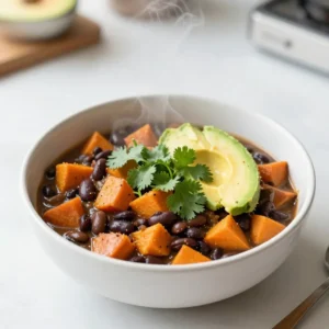 To make a great Sweet Potato Black Bean Chili, you need some key items. Here&rsquo;s what you&rsquo;ll want to gather: - 2 medium sweet potatoes, peeled and diced into 1-inch cubes - 1 can (15 oz) black beans, thoroughly rinsed and drained - 1 can (14 oz) diced tomatoes, including their juices - 1 small onion, finely chopped - 3 cloves garlic, minced - 1 red bell pepper, chopped into bite-sized pieces - 2 tablespoons extra-virgin olive oil - 2 cups vegetable broth, or more as needed - 1 tablespoon chili powder - 1 teaspoon ground cumin - 1 teaspoon smoked paprika - Salt and black pepper, to taste - Fresh cilantro, chopped, for garnish (optional) - Slices of ripe avocado, for serving (optional) These ingredients come together to create a hearty and filling meal. For toppings, I like to add fresh cilantro and ripe avocado. They add flavor and color to your dish. You can also use lime wedges for a burst of freshness. If you don&rsquo;t have a certain ingredient, substitutions are easy. You can use any beans you have on hand. Cannellini or pinto beans work well too. If you prefer, you can swap out sweet potatoes for butternut squash or regular potatoes. Adjust the spices based on your taste. If you want more heat, add some jalape&ntilde;os. These options make this dish flexible while keeping it delicious. Enjoy creating your own version of this chili! {{ingredient_image_2}} 1. Start by heating 2 tablespoons of olive oil in a large pot over medium heat. Wait until it shimmers, then add the chopped onion. Cook for about 5 minutes. Stir it often. The onion should turn soft and clear. 2. Next, add 3 minced garlic cloves and 1 chopped red bell pepper to the pot. Cook for 2-3 minutes. The bell pepper should become tender, and the mix will smell good. 3. Now, add 2 diced sweet potatoes to the pot. Stir them with the onion and pepper. Let them cook for about 5 minutes. Keep stirring to stop any sticking. 4. Sprinkle 1 tablespoon of chili powder, 1 teaspoon of ground cumin, 1 teaspoon of smoked paprika, salt, and black pepper over the mix. Stir it well. The spices should coat the sweet potatoes evenly. 5. Pour in 1 can of diced tomatoes with their juices and 2 cups of vegetable broth. Gently fold in 1 can of black beans. Bring the chili to a boil. 6. Lower the heat to a gentle simmer. Cover the pot with a lid. Let it simmer for 25-30 minutes. Check the sweet potatoes to see if they are soft. You can pierce them with a fork. 7. Taste the chili. Adjust the seasoning with more salt, pepper, or spices if needed. If the chili is too thick, slowly add more broth or water until it&rsquo;s just right. 8. Serve it hot. Top with chopped fresh cilantro and slices of creamy avocado. This adds flavor and makes it look nice. - Stir the pot often to cook everything evenly. - Cut sweet potatoes into similar sizes for even cooking. - If you like softer sweet potatoes, let the chili simmer a bit longer. To check if sweet potatoes are done, poke them with a fork. If it goes in easily, they are cooked. If not, let them simmer a bit longer. Enjoy your chili! 1. How to enhance flavor with spices Use spices like chili powder and cumin for depth. Smoked paprika adds a rich, smoky taste. Always toast spices in oil briefly before adding other ingredients. This step releases their full flavor. 2. Tips for thickening the chili if too watery If your chili is too watery, mash some sweet potatoes with a fork. This will help thicken the mix. You can also add more beans to absorb liquid. Let it simmer longer to reduce excess broth. 3. Best practices for chopping vegetables Cut sweet potatoes into even cubes for uniform cooking. Use a sharp knife for easy slicing. Chop onions and bell peppers small to help them cook faster. Always keep your fingers curled when chopping for safety. Pro Tips Choose the Right Sweet Potatoes: Opt for firm, smooth-skinned sweet potatoes without blemishes for the best flavor and texture in your chili. Enhance the Flavor with Fresh Herbs: Adding fresh herbs like oregano or thyme can elevate the overall taste profile of your chili. Customize Your Spice Level: Adjust the amount of chili powder or add fresh jalape&ntilde;os for a spicier kick, depending on your heat preference. Make It a Meal: Serve the chili over cooked quinoa or brown rice for added protein and a heartier dish. {{image_4}} You can make this Sweet Potato Black Bean Chili your own with fun changes. - Adding Protein: Want a meaty boost? Try ground turkey or beef. Brown it first with the onion. For a veggie option, use lentils or tofu. Both add protein without losing flavor. - Different Vegetables: Mix in corn, zucchini, or spinach. These veggies add color and taste. You can also use butternut squash if you like more sweetness. - Adjusting Spice Levels: Start mild, then spice it up! Add jalape&ntilde;os for heat. For a smoky flavor, toss in chipotle peppers. If you prefer a softer taste, skip the heat and focus on herbs. Feel free to play with these ideas. Your chili, your way! To keep your Sweet Potato Black Bean Chili fresh, follow these simple tips: - Refrigerating: Place your leftover chili in an airtight container. It will stay good for about 3 to 5 days in the fridge. When you want to eat it again, heat it on the stove or in the microwave. Stir often to ensure it heats evenly. - Freezing: If you want to save it for later, freezing is a great choice. Use freezer-safe containers or bags. Leave some space for expansion. This chili can last for up to 3 months in the freezer. When you&rsquo;re ready, thaw it overnight in the fridge before reheating. - Shelf Life: In the fridge, your chili should taste great for up to 5 days. In the freezer, it maintains its flavor for about 3 months. Always check for any off smells or changes in color before eating leftovers. Enjoy your delicious chili later! Yes, Sweet Potato Black Bean Chili is both vegan and gluten-free. It uses no animal products, and all ingredients are naturally free from gluten. This makes it a great option for those with dietary restrictions. Absolutely! To make this chili in a slow cooker, start by saut&eacute;ing the onion, garlic, and bell pepper in a pan. Then, transfer them to the slow cooker with the other ingredients. Cook on low for 6-8 hours or on high for 3-4 hours. This method will meld the flavors beautifully. To add heat, try these options: - Include fresh chopped chili peppers. - Add cayenne pepper or crushed red pepper flakes. - Use a spicier chili powder. Start with a small amount and adjust to taste. Enjoy the flavor boost! This blog post covered everything you need to make Sweet Potato Black Bean Chili. You learned about the key ingredients and optional toppings. I shared step-by-step cooking instructions and gave tips for flavor and texture. We also explored recipe variations and storage advice. I hope you feel inspired to try this recipe. It&rsquo;s a healthy, tasty meal that&rsquo;s easy to make! Enjoy cooking and make it your own!
